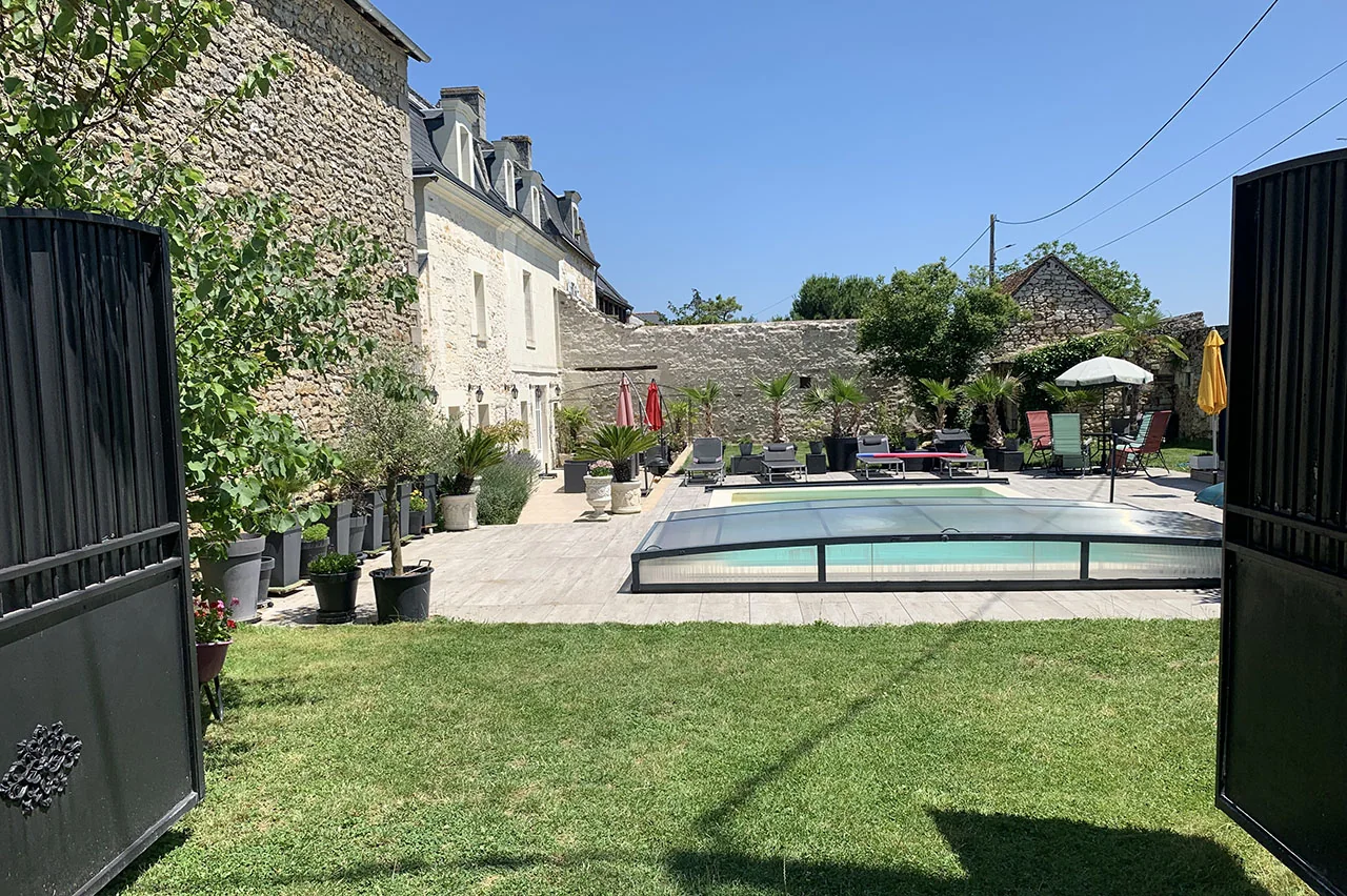 Vue du jardin et de la piscine depuis le portail